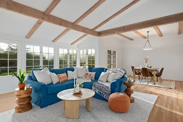 Whole-house interior renovation in Santa Barbara with exposed ceiling beams, wide windows and an open dining area